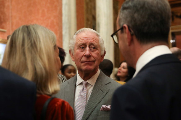 King Charles III speaks to guests during a reception at Buckingham Palace this week.