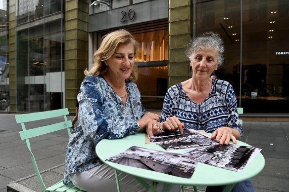 Debbie Ditchfield (left) and her sister Janet France (right) with historical photos of their grandfather Mick Adams who owned the Black and White 4d Milk Bar in Martin Place. 