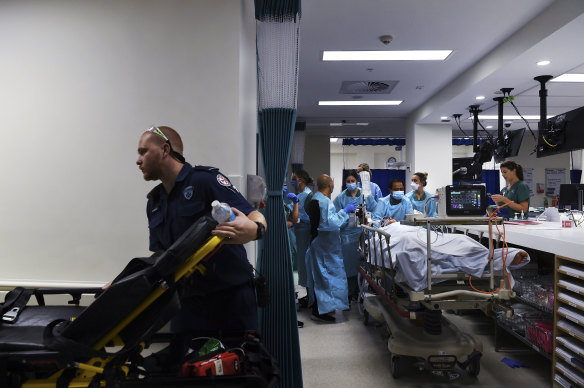 A paramedic moves a stretcher in St Vincent’s Hospital emergency department as staff move a patient after a scan.