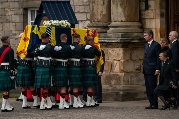 Vice Admiral Timothy Laurence, Britain’s Sophie, Countess of Wessex and Britain’s Prince Andrew, Duke of York look on as Britain’s Princess Anne, Princess Royal curtseys.