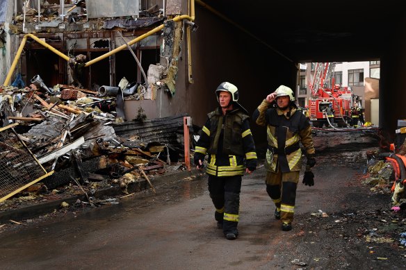 Firemen at the scene of a Kyiv apartment building hit by a missile attack on Sunday.