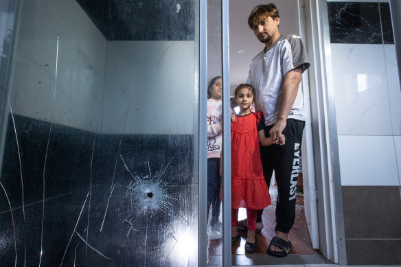 Baryalai Rahmanzai and his two daughters at their home in Dandenong. 