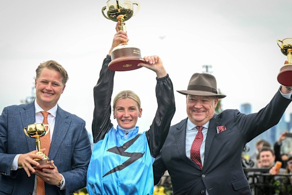 Calvin and Tony McEvoy share centre stage with jockey Jamie Melham after their Cup win.