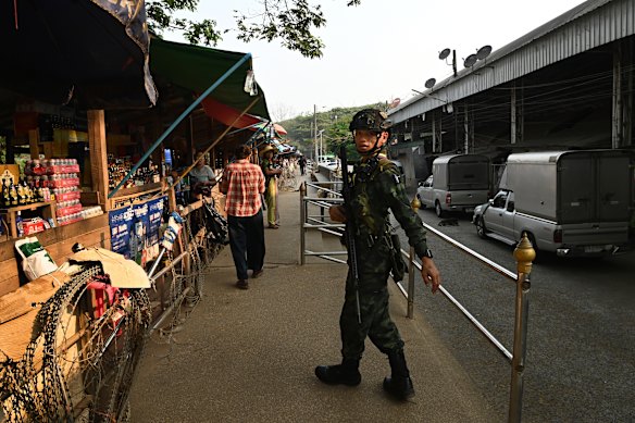 A Royal Thai Army soldier patrols the market located on a sandbar in the middle of the Moei River, that separates Thailand and Myanmar.  