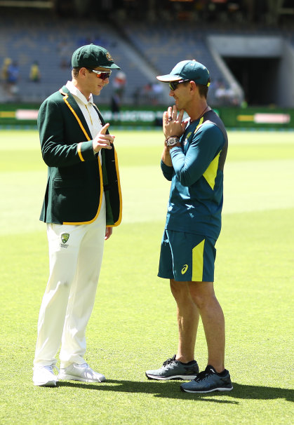 Langer on the pitch with Australian Test captain Tim Paine during the second Test against India, in December 2018.