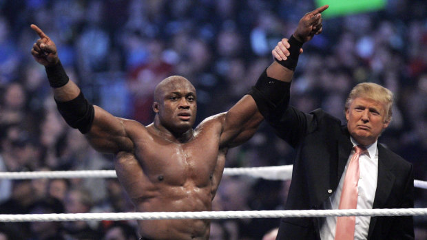Donald Trump raises the arm of wrestler Bobby Lashley after he defeated Umaga at WWE's Wrestlemania 23 in 2007.