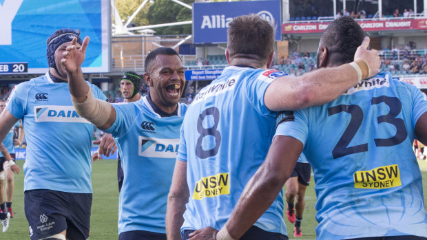 Right formula: Kurtley Beale rushes in to congratulate Taqele Naiyaravoro on his try as the Waratahs finish strongly.