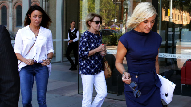 Sarah Walker (right) leaving court on Wednesday, trailed by her sister Kate Hertogs and their mother Jennifer.
