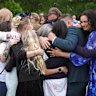 The Roberts family and survivors embrace each other during the vigil.
