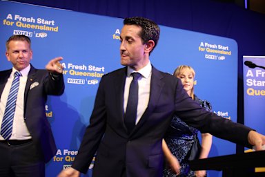 David Crisafulli on stage with deputy Jarrod Bleijie, and wife Tegan, during his 2024 Queensland election victory speech.