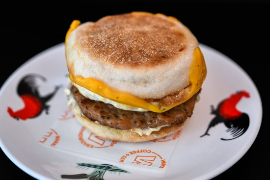 A breakfast muffin with sausage, egg, cheese and “Bazzinga” sauce at Warkop in the Melbourne CBD.