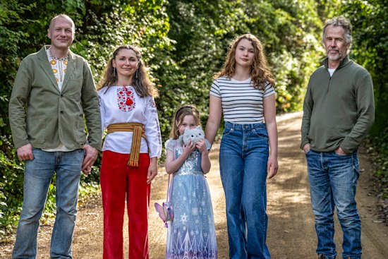 Chemical engineer Mark Corrigan (right) and his neighbours Tetiana and Oleksandr Tkachuk, with daughters Sophia and Maria.  