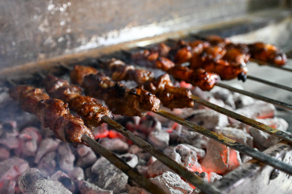 Lamb skewers are marinated overnight and grilled over charcoal.