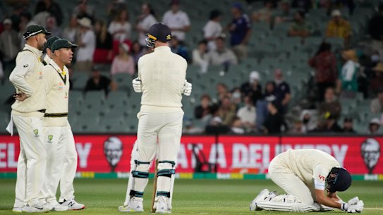 Joe Root doubles over in pain after being hit by a delivery from Mitchell Starc late on Sunday.