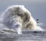 Waves crash against the lighthouse in Seaham Harbour, England.