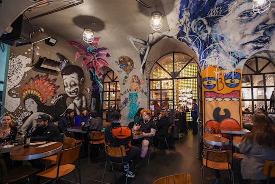 Bar Ampere's concrete tunnel swept with bohemian artworks.