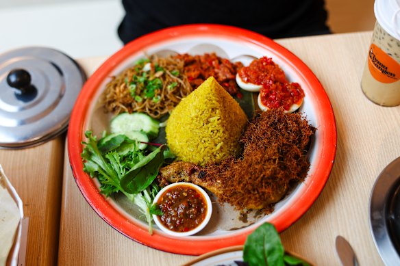 Nasi kuning (cone-shaped towers of rice tinted yellow with turmeric).