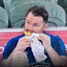 Patrick Dangerfield enjoys a kebab on the bench after being subbed out by Geelong in the game against North Melbourne.