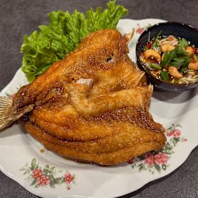 Crispy fried sea bass with fish sauce.