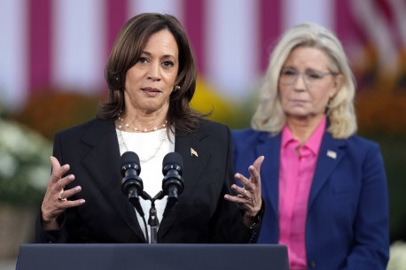 Democratic presidential nominee Vice President Kamala Harris speaks with former representative Liz Cheney, at a campaign rally in Wisconsin.