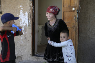 Alif Baqytali hugs his mother, Gulnar Omirzakh, at their new home in Shonzhy, Kazakhstan. Omirzakh, a Chinese-born ethnic Kazakh, says she was forced to get an intrauterine contraceptive device, and that authorities in China threatened to detain her if she didn't pay a large fine for giving birth to Alif, her third child. 