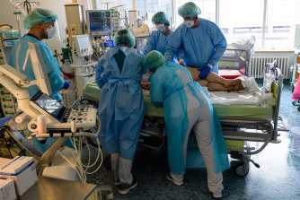 Doctors and nurses tend to a patient on the COVID-19 intensive care unit at University Hospital Leipzig, Germany, on Thursday.