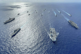 Japanese destroyers with US and British carriers pictured during recent operations in the Philippine Sea. China’s military challenges to Japan and the region are escalating.