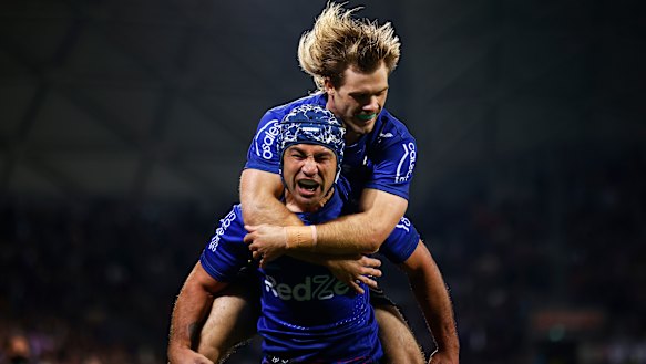 Jahrome Hughes celebrates a try with Ryan Papenhuyzen.