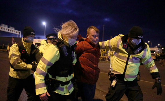 A man is detained by Police officers after a scuffle at the Port of Dover.