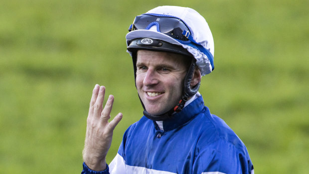 Tommy Berry gestures after riding his fourth winner for the day on board Mubariz in race 8, the Precise Air Handicap, at Rosehill.