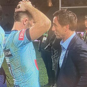 Andrew Johns and Nathan Cleary share a private moment on the field after the Origin decider.