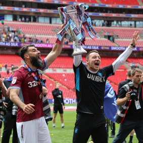Mile Jedinak and John Terry celebrate Aston Villa's Championship play-off triumph in May last year.