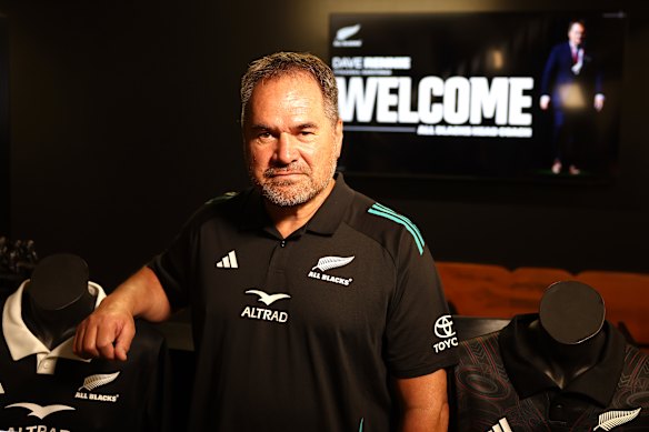 Dave Rennie posing in his new All Blacks  attire.