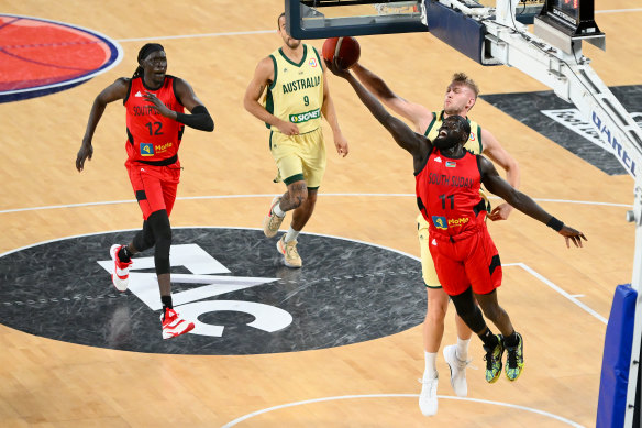 Marial Shayok of South Sudan and Jock Landale of Australia reach for the ball. Landale was injured in this contest.