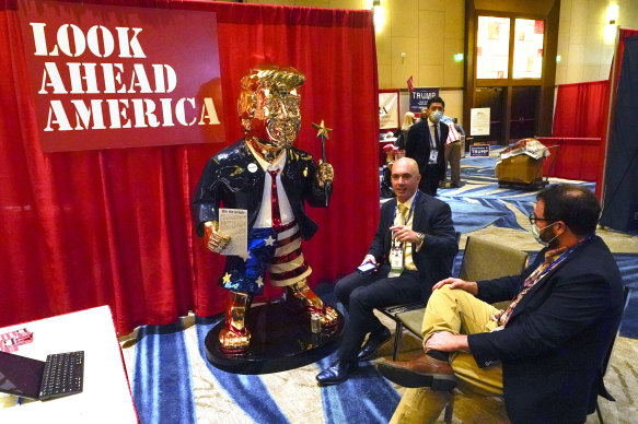 Matt Braynard, centre, talks to Conservative Political Action Conference attendees at his booth at the event in Florida in 2021.