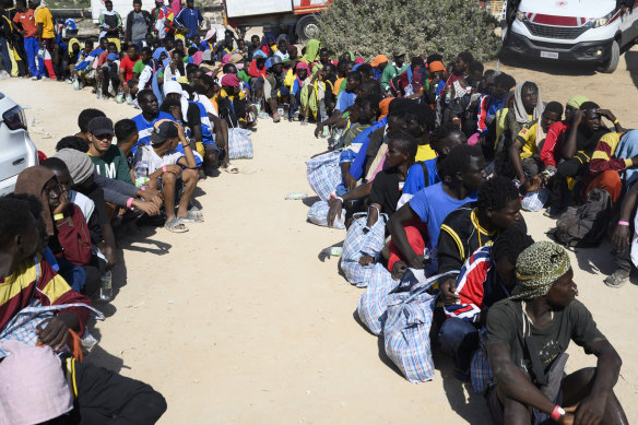 Asylum seekers queue at the migrant reception centre in Italy’s southernmost island of Lampedusa.