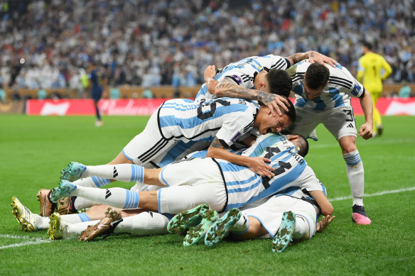 Argentina’s players mob Lionel Messi after his first goal against France.