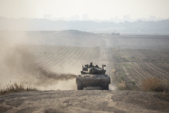 An Israeli tank moves a long the border with the Gaza Strip as seen from a position on the Israeli side of the border.