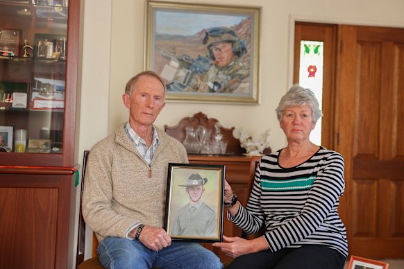 Hugh and Janny Poate at their home in Canberra with a photograph of their son Private Robert Poate. Janny Poate paid tribute at the service. 