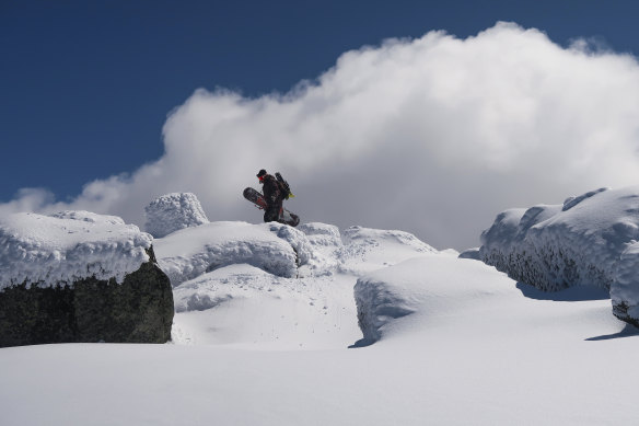 A snowboarder ascending Mount Tate in the Snowy Mountains.