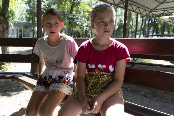 Ukrainian children Olesya Lyadchenko, left, and Yaroslava Rogachyova attend a camp in 
 southwestern Russia.  Russia’s strategy to take Ukrainian orphans and bring them up as Russian is well underway. 