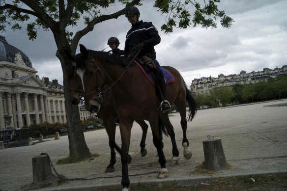 Mounted Police patrol on the Champ de Mars in Paris during the national coronavirus lockdown.