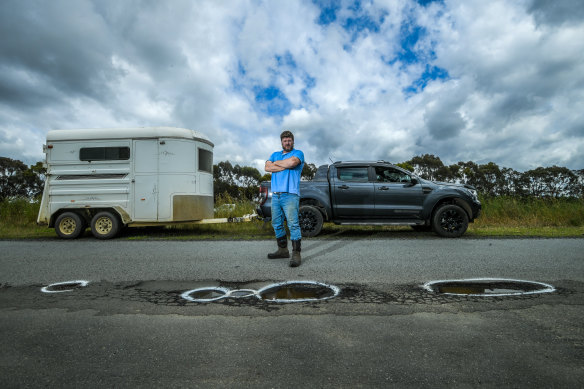 Luke Anderson is one of many Victorians facing the daily challenge of dodging potholes after devastating rain last month. 