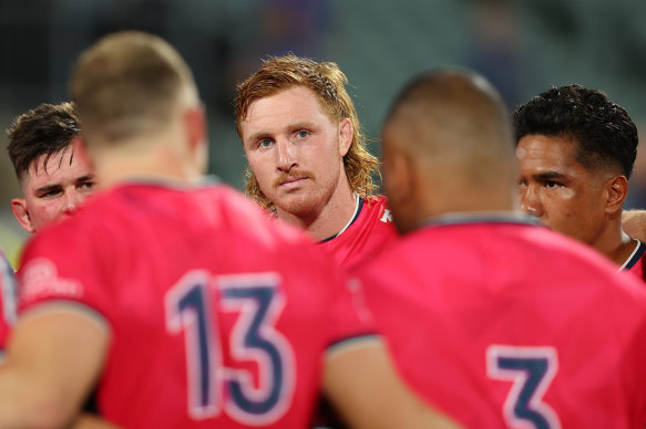 Brad Wilkin listens on in the Rebels huddle.