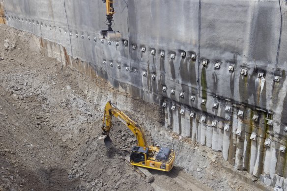 A digger excavates a giant hole for a station in Rozelle for Metro West early this year.