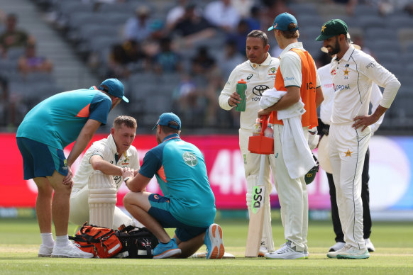 Marnus Labuschagne is treated for a hand injury he suffered on Saturday.