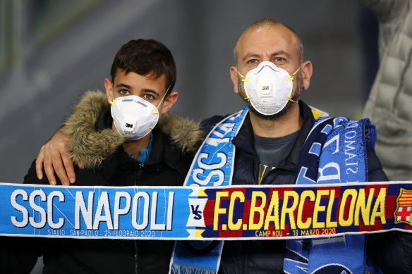 Fans were face masks at the Champions League match between Napoli and Barcelona in Italy.
