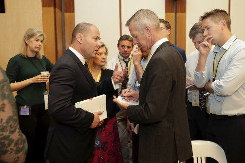 Treasurer Josh Frydenberg speaks with Peter Hartcher during the budget lockup in 2019. 