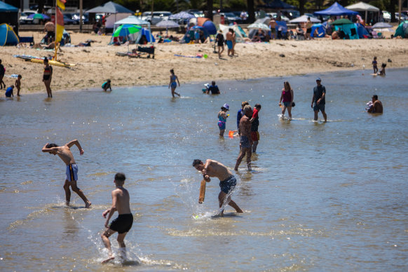Beachgoers cool down at Altona on December 27.
