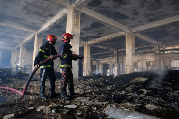 Firefighters work to douse a fire at the food and beverage factory in Rupganj, outside Dhaka.